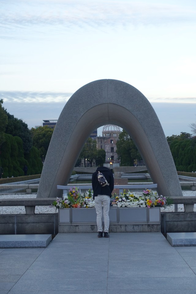man bowing at cenotaph