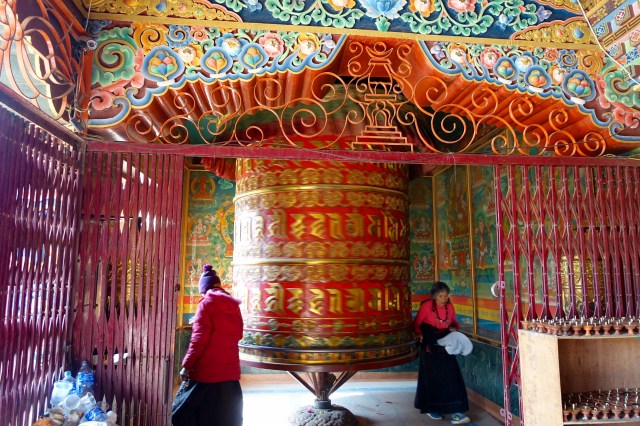 praying by boudhanath stupa