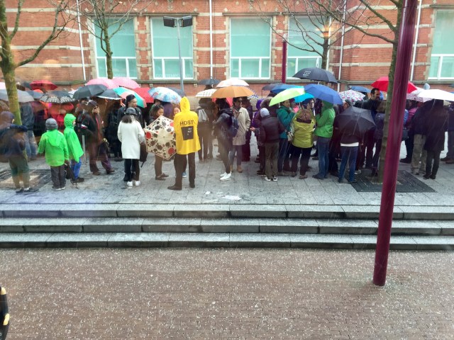 happy that we aren't in the line, in the rain but are inside already:)