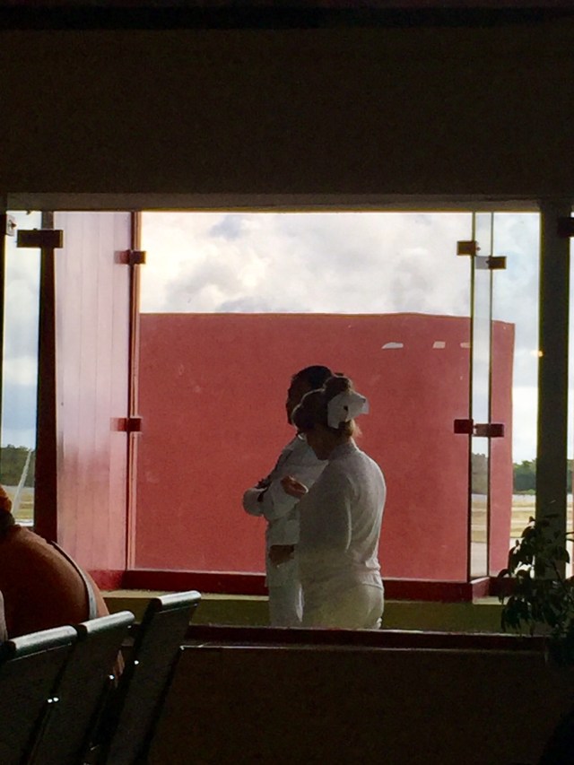these ladies check travel documents for illnesses, dressed like 1950's nurses.